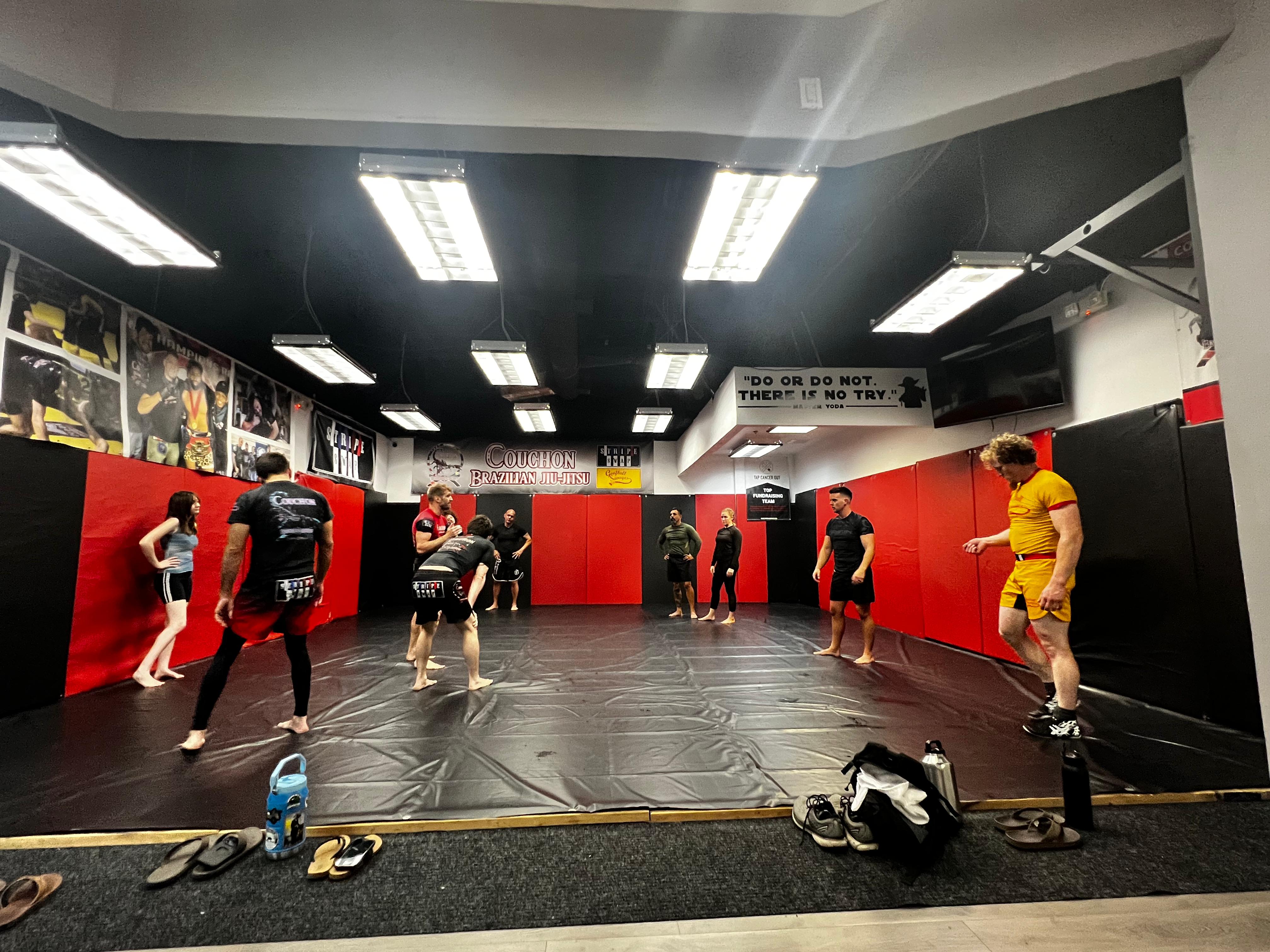 Adults training on the mat at Couchon Brazilian Jiu-Jitsu